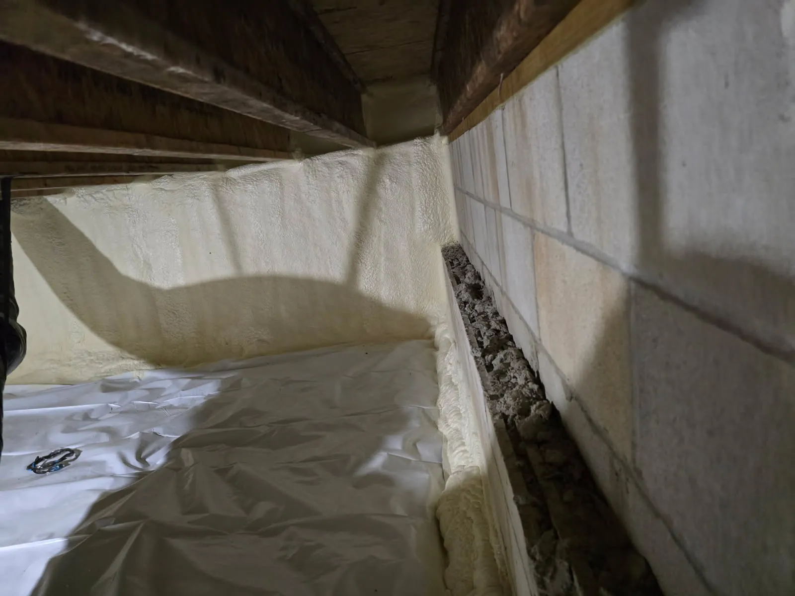 Crawl space insulation with spray foam on block walls and vapor barrier